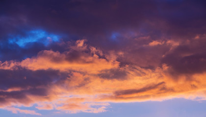 Naklejka na ściany i meble Evening sky at sunset. Dark dramatic clouds during the sunset_