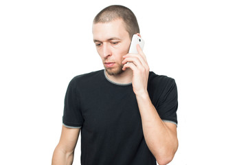 a man in a black shirt talking on the phone on a white background
