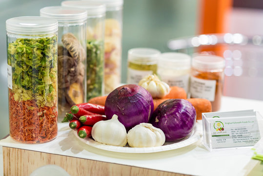 Dried Vegetables In Glass Jars, Onions, Beets, Carrots, Pumpkin, Bay Leaf, Banks On Wooden Background. Superfoods, Herbs.