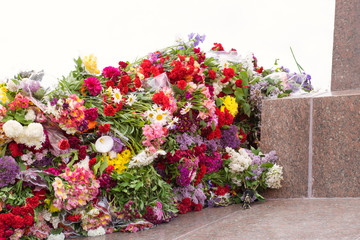 Many flowers at the monument to fallen soldiers