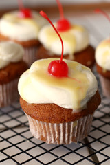 Homemade bakery style vanilla delicious sponge cake with white cream frosting and yellow lemon syrup curd  with cherry on top. Candy bar for celebrating partys and birthdays
