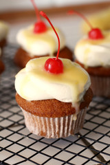 Homemade bakery style vanilla delicious sponge cake with white cream frosting and yellow lemon syrup curd  with cherry on top. Candy bar for celebrating partys and birthdays