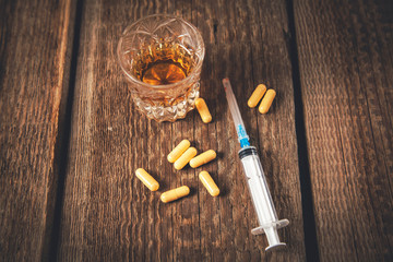 drug with syringe and whiskey