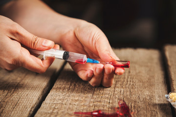 woman hand syringe with drug