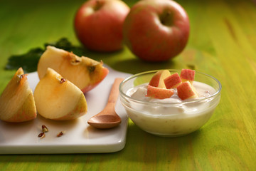 apple yogurt in the glass bowl with fruit around - closeup