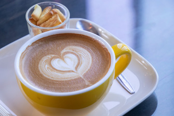 Coffee cup with latte art foam on wood table in coffee shop with copy space.Coffee is one of the most popular beverages.Improve Energy Levels and Burn Fat