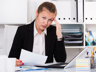 Female in black suit is having complicated issue with project