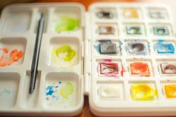 watercolor set in white box with brush closeup