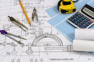 Engineer's drawing with tools and calculator close up