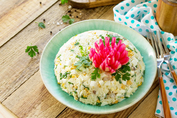 Festive snack on Easter table. Salad with Rice, Onion, Egg, Corn and Mushrooms on table. Copy space.