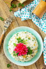 Festive snack on Easter table. Salad with Rice, Onion, Egg, Corn and Mushrooms on table. Top view flat lay background.