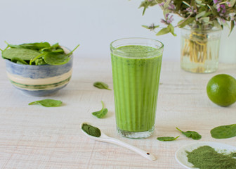 Detox, healthy green smoothie in a glass with matcha and spinach 