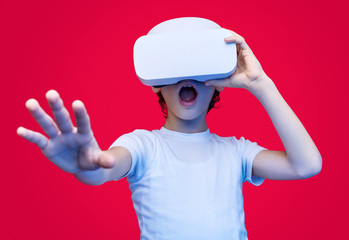 Amazed kid experiencing virtual reality in glasses