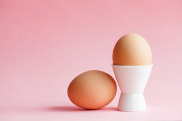 chicken eggs isolated on pastel pink background