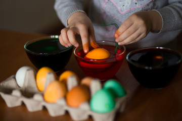 Happy easter. Little girl painter painted eggs. Kid preparing for Easter. Painted hand. Art and craft concept. Traditional spring holiday food
