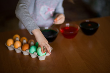 Happy easter. Little girl painter painted eggs. Kid preparing for Easter. Painted hand. Art and craft concept. Traditional spring holiday food