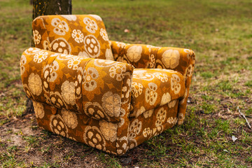 Abandoned armchair outdoor on street green surface