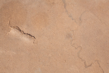 Old fibreboard with crack and stains. Texture background