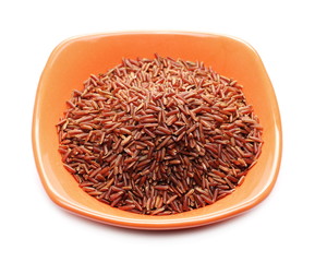 Red wild rice pile in porcelain bowl isolated on white background