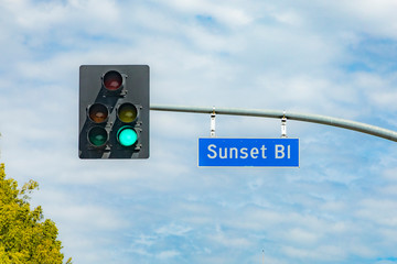 street name Sunset Boulevart  in Hollywood with red traffic light