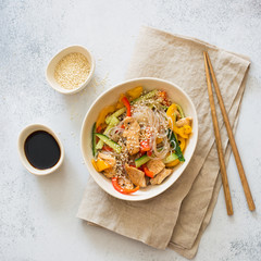 Rice noodles with vegetables, chicken meat and sesame