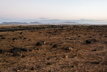 Obraz premium Scenic view of volcanic landscape at sunset