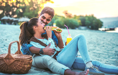 Beautiful young couple having fun on the beach. Lifestyle, love, dating, vacation concept