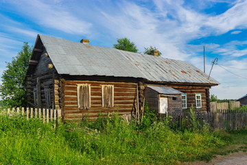 old wooden house in the village on a summer day