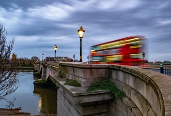 Foto op Plexiglas Putney bridge early in the morning at twilight and public transport by traditional red bus in motion in London, UK © cristianbalate