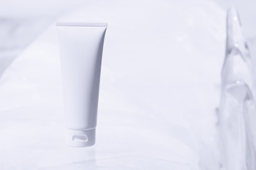 body lotion cream for healthy spa cosmetic, sunscreen spf bottle, facial foam cleansing tube package, medical skincare product, cold ice background