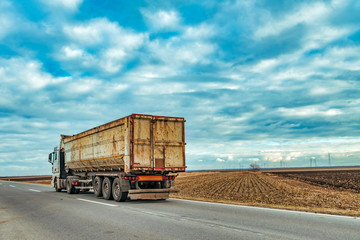 Truck on the road through countryside