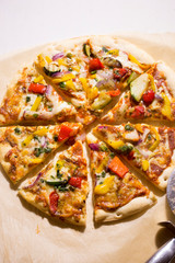 Pizza with grilled vegetables: courgette, peppers, red onion & green pesto