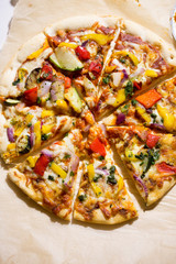 Pizza with grilled vegetables: courgette, peppers, red onion & green pesto