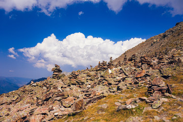 A large panorama of the Caucasus Mountains, where the glacier is located in the vicinity of Dombai. And on the tops of snow lies. Cloudy summer day.