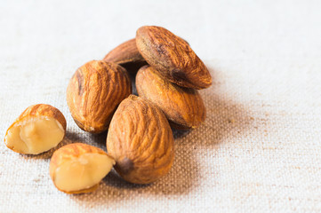 Healthy snack - almond. Organic nuts close-up on the light background