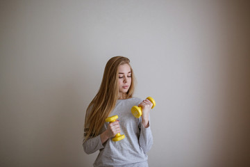 student doing exercises with dumbbells,home sports