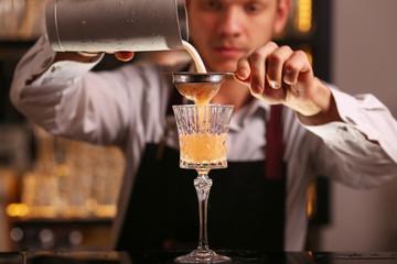 Bartender is making Pisco sour alcohol cocktail drink. Pisco sour cocktail drink with ice cubes