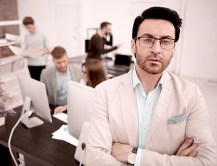 pensive businessman standing in his office