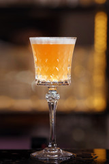 Bartender is making Pisco sour alcohol cocktail drink. Pisco sour cocktail drink with ice cubes