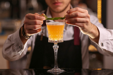Bartender is making Pisco sour alcohol cocktail drink. Pisco sour cocktail drink with ice cubes