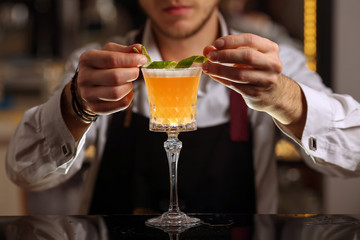 Bartender is making Pisco sour alcohol cocktail drink. Pisco sour cocktail drink with ice cubes