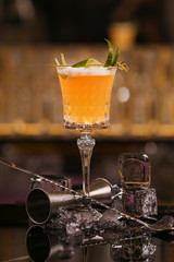 Bartender is making Pisco sour alcohol cocktail drink. Pisco sour cocktail drink with ice cubes