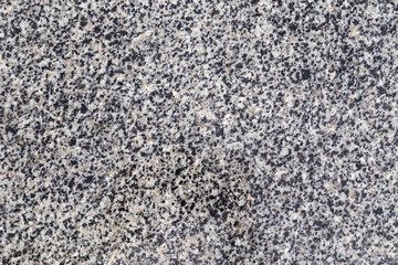 Gray granite stone background. Aged rough rock material texture top view