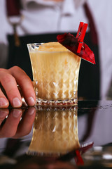 Batida alcohol cocktail drink with mint making by bartender. 