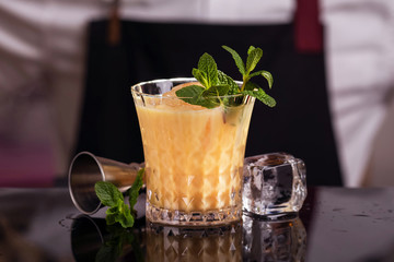 Batida alcohol cocktail drink with mint making by bartender. 