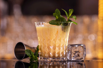 Batida alcohol cocktail drink with mint making by bartender. 