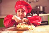 Dough home cuisine. Portrait of little cute child girl chef.