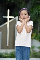 Surprised Filipina Child And Cross
