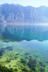 Picturesque mountain range and its reflection in clear water.