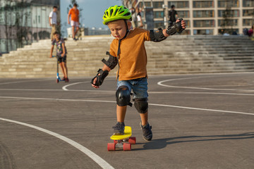 A little boy enjoys a yellow cruiser penny plastboard